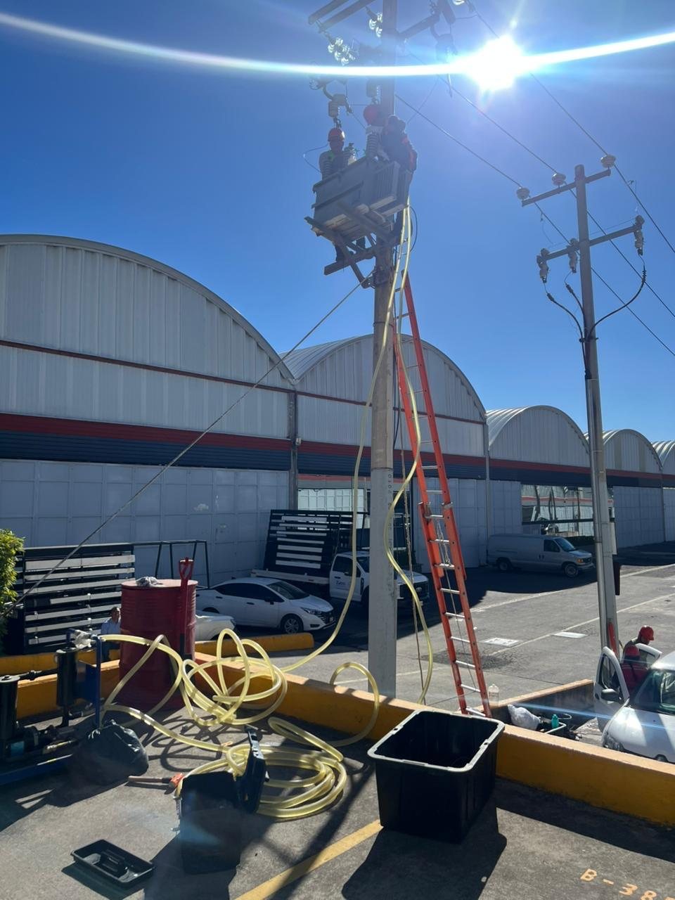 Técnicos trabajando en un transformador montado en poste